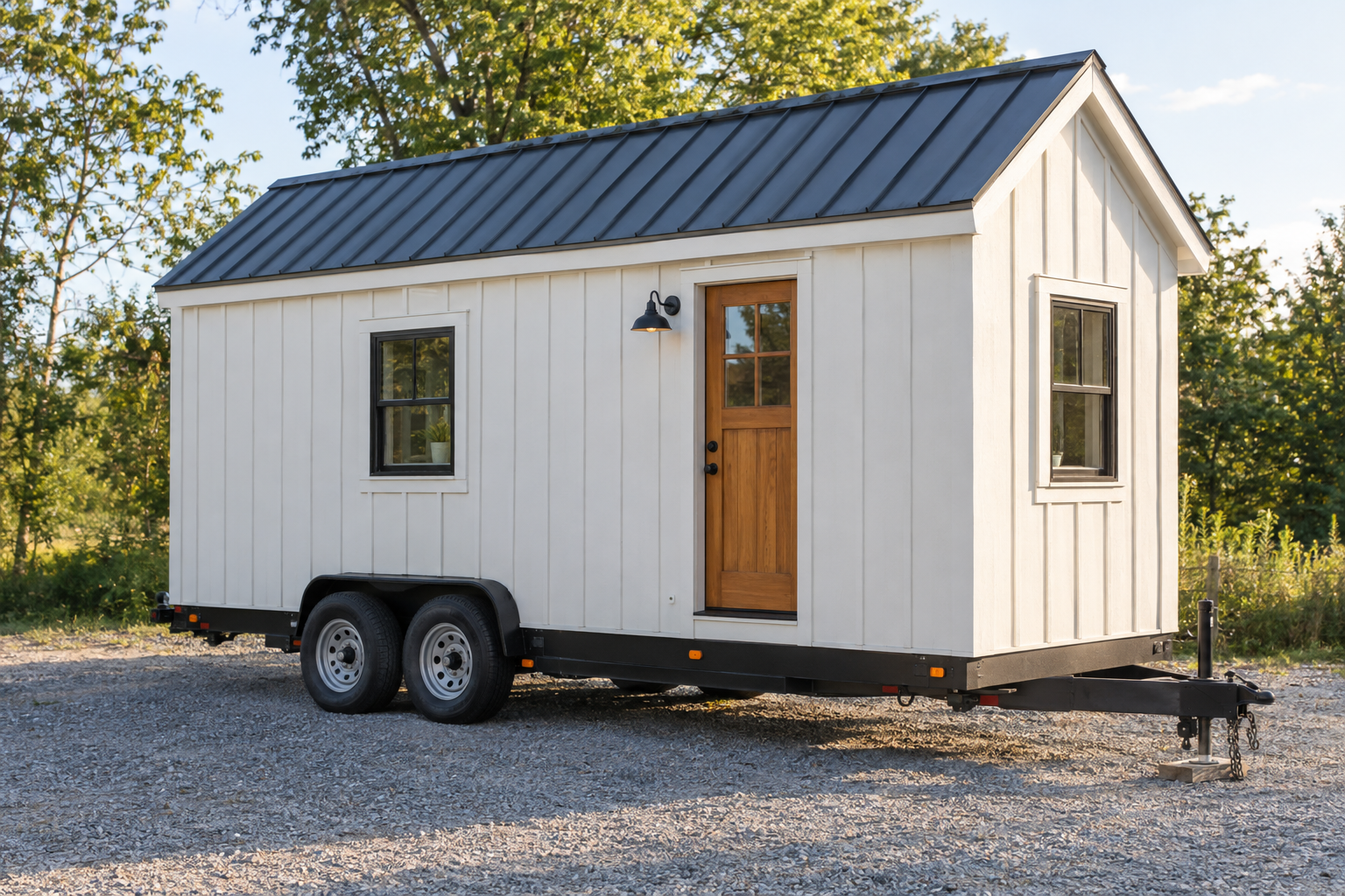 Completed DIY tiny home on wheels parked on a sunny gravel lot